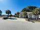 Inviting single-story home with a well-manicured lawn, mature trees, and a spacious driveway under a clear sky at 1501 Brighton Ln., Longs, SC 29568