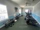 A fitness center with modern exercise equipment and natural light provides residents with a convenient workout area at 1501 Brighton Ln., Longs, SC 29568