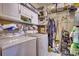 Laundry room with ample shelving space and full size washer and dryer at 1501 Brighton Ln., Longs, SC 29568