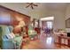 Spacious living room with hardwood floors, green armchairs, and a view of the dining room at 1501 Brighton Ln., Longs, SC 29568