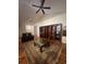 Bright living room featuring hardwood floors, vaulted ceilings, two ceiling fans, and a stylish area rug at 1501 Brighton Ln., Longs, SC 29568