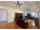 Spacious living room with hardwood floors, ceiling fans, a large built-in bookshelf, and comfortable seating at 1501 Brighton Ln., Longs, SC 29568
