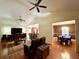 Open-concept living room with hardwood floors, ceiling fans, seamless flow to kitchen bar and dining space at 1501 Brighton Ln., Longs, SC 29568