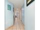 Light blue hallway with tile floors and beach decor at 205 74Th Ave. N # 1603, Myrtle Beach, SC 29572