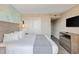 Well-furnished bedroom with closet, dresser, and a wall-mounted television at 2106 N Ocean Bl N Ocean Blvd. # 211, Myrtle Beach, SC 29577