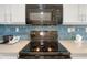 Close-up of a modern kitchen with a black microwave and stove at 2106 N Ocean Bl N Ocean Blvd. # 211, Myrtle Beach, SC 29577