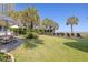 Expansive lawn and lounge chairs beneath lush palms lead to ocean views at 2106 N Ocean Bl N Ocean Blvd. # 211, Myrtle Beach, SC 29577