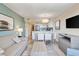 Open-concept living area features a TV, sofa, dining table with six chairs, a bar, and the fully-equipped kitchen at 2106 N Ocean Bl N Ocean Blvd. # 211, Myrtle Beach, SC 29577