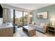 Bright living room featuring a sofa, chair, table, and access to a balcony overlooking the ocean and palm trees at 2106 N Ocean Bl N Ocean Blvd. # 211, Myrtle Beach, SC 29577
