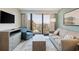 Relaxing living room with light blue walls, a comfy sofa and chair, a table, and curtains leading to a balcony at 2106 N Ocean Bl N Ocean Blvd. # 211, Myrtle Beach, SC 29577