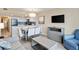 Inviting open-concept living area with a sofa, a dining table with six chairs, and a TV, creating a perfect space at 2106 N Ocean Bl N Ocean Blvd. # 211, Myrtle Beach, SC 29577