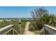 Wooden walkway leading to a sandy beach and ocean at 2311 South Ocean Blvd. # 371, Myrtle Beach, SC 29577