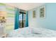 Bedroom with ocean view, light blue walls, and coastal decor at 2311 South Ocean Blvd. # 371, Myrtle Beach, SC 29577