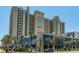 Multi-story resort building with parking and palm trees at 2311 South Ocean Blvd. # 371, Myrtle Beach, SC 29577