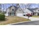 Two-story house with a teal door, white garage door, and a red truck parked in the driveway at 237 Chesapeake Ln., Murrells Inlet, SC 29576