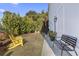 Landscaped backyard with yellow chairs and a black bench at 244 Gloucester Way, Little River, SC 29566