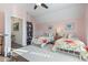 Bright bedroom with twin beds, access to an office, and a ceiling fan at 244 Gloucester Way, Little River, SC 29566