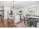 Modern white kitchen with island, stainless steel appliances, and breakfast nook at 244 Gloucester Way, Little River, SC 29566