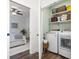 Convenient laundry room with washer, dryer, and storage shelves at 244 Gloucester Way, Little River, SC 29566
