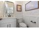 Stylish powder room with marble vanity and decorative wallpaper at 244 Gloucester Way, Little River, SC 29566