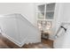 Elegant staircase with hardwood floors and tasteful wall art at 244 Gloucester Way, Little River, SC 29566