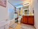 Bright bathroom with a tub, shower combo and wooden vanity at 344 Tall Palms Way, Little River, SC 29566