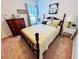 Cozy bedroom with a wooden bed frame, soft lighting, and carpeted floors at 344 Tall Palms Way, Little River, SC 29566