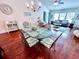 Dining room with glass table and wood floors that flows into the living room at 344 Tall Palms Way, Little River, SC 29566