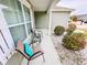 Charming front porch with seating area and beautifully landscaped surroundings at 344 Tall Palms Way, Little River, SC 29566