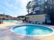 Inviting hot tub near a community pool with lounge chairs on a brick patio at 344 Tall Palms Way, Little River, SC 29566