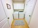 Well-lit laundry room with modern washer, dryer, and overhead cabinets at 344 Tall Palms Way, Little River, SC 29566