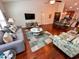 Open-concept living room and dining area, with a comfortable sofa and hardwood floors at 344 Tall Palms Way, Little River, SC 29566
