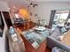 Spacious living room with wood floors, comfortable seating, and an open layout to the dining area at 344 Tall Palms Way, Little River, SC 29566