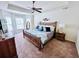 Main bedroom with tray ceilings, ceiling fan and large windows at 344 Tall Palms Way, Little River, SC 29566