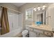 Bright bathroom featuring a shower-tub combo, single sink vanity, and natural light from the window at 3501 Dunes St. # 2, North Myrtle Beach, SC 29582