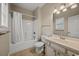 Neat bathroom featuring a shower-tub combo, single sink vanity with white cabinets, and tile flooring at 3501 Dunes St. # 2, North Myrtle Beach, SC 29582