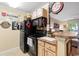 Black appliances, wood cabinets, and kitchen island with seating at 3786 Hitchcock Way # 312, Myrtle Beach, SC 29577