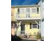 Charming yellow two-story home with balcony and American flag at 3866 Highway 17 Business # C-3, Murrells Inlet, SC 29576