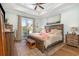 Main bedroom with king-size bed, private balcony access, and coastal decor at 406 Pine Ave., Murrells Inlet, SC 29576