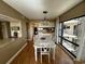 White dining table with six chairs, located near the kitchen at 423 Parker Dr. # 511, Pawleys Island, SC 29585