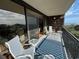 Spacious balcony overlooking the ocean with seating for two and a blue patterned rug at 423 Parker Dr. # 511, Pawleys Island, SC 29585