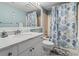 Well-lit bathroom featuring a marble vanity, modern fixtures and a tub with a nautical-themed shower curtain at 4390 Bimini Ct. # 206-C, Little River, SC 29566