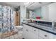 Bright bathroom features a granite vanity, modern fixtures and a tub with a seashell-themed shower curtain at 4390 Bimini Ct. # 206-C, Little River, SC 29566
