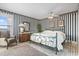 Stylized bedroom with an accent chair and a large window at 4390 Bimini Ct. # 206-C, Little River, SC 29566