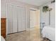 Bedroom featuring tile flooring, a closet with bi-fold doors, and neutral wallpaper at 4390 Bimini Ct. # 206-C, Little River, SC 29566