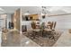 Cozy dining area with seating for six and tiled floor next to the kitchen area at 4390 Bimini Ct. # 206-C, Little River, SC 29566