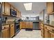 Open kitchen featuring stainless steel appliances, granite countertops, and wooden cabinets that overlook the water at 4390 Bimini Ct. # 206-C, Little River, SC 29566