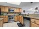 A bright kitchen equipped with stainless steel appliances, granite countertops, and ample cabinet space at 4390 Bimini Ct. # 206-C, Little River, SC 29566
