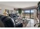 Bright living room featuring tile flooring and sliding glass doors to the balcony at 4390 Bimini Ct. # 206-C, Little River, SC 29566