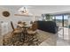 Living room with sliding doors that lead to a balcony overlooking the marina at 4390 Bimini Ct. # 206-C, Little River, SC 29566